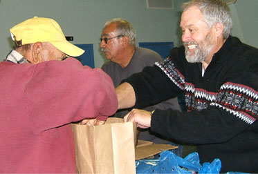 Volunteers helping bag items